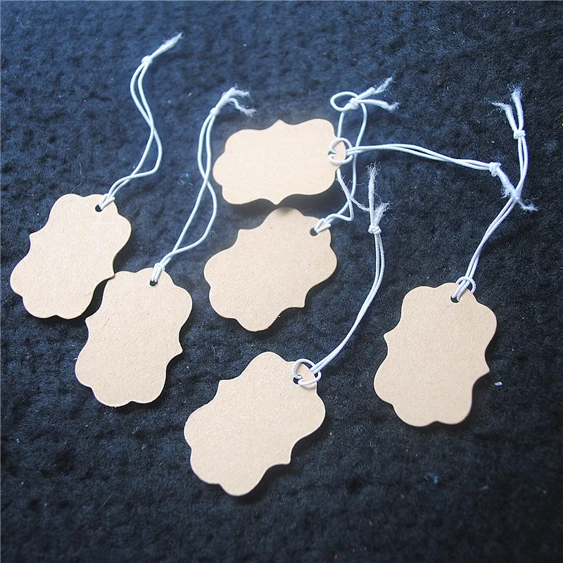 1000PCS BROWN PAPER TAGS SLIM SHAPES SIZE 33X23MM WITH ELASTIC WIRE GOOD FOR YOUR SELLING ITEMS AND CRAFTS