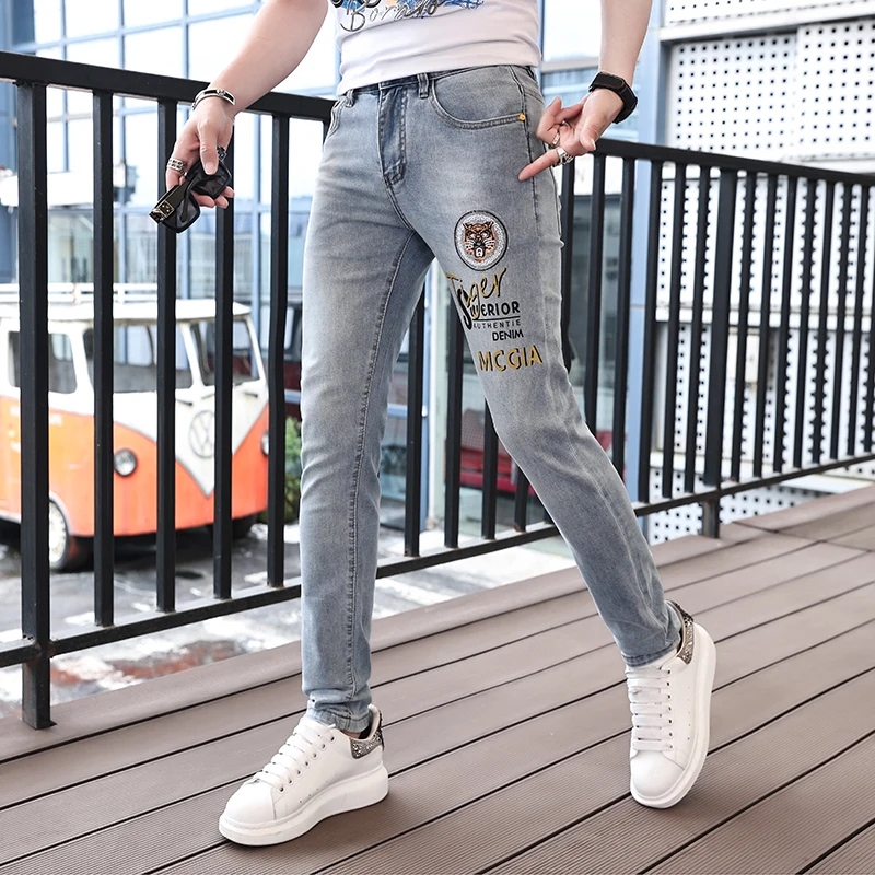 

2024 spring and summer blue tiger embroidery men's jeans slim small feet trend casual printing light-colored pants