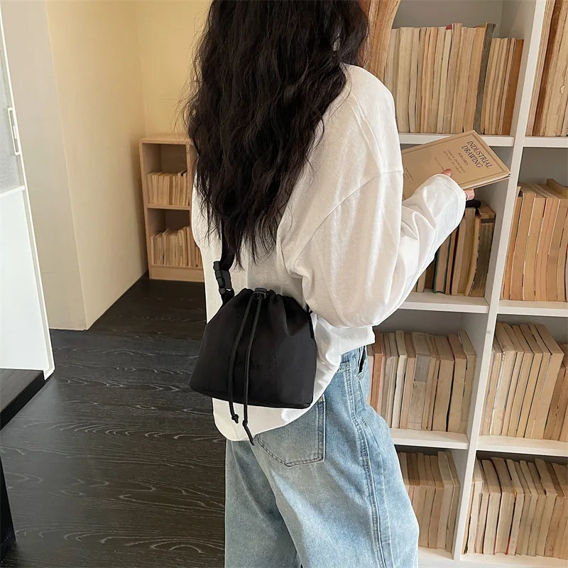 Women's Black Nylon Drawstring Bucket Bag with Adjustable Strap and Logo Detail Minimalist Crossbody Sling Purse for Daily