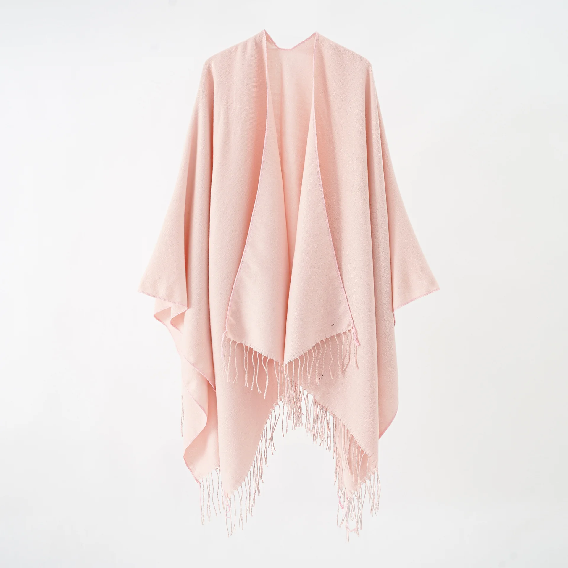 A woman\'s shawl a plain-colored, monochrome cape with a large split shawl and imitation cashmere tassels