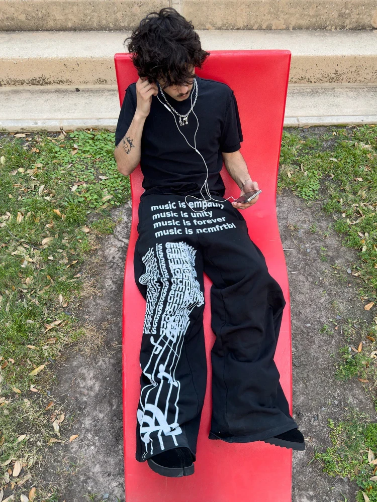 

Men's black wide leg pants, hip-hop cotton pants with music graffiti, white text printing, casual streetwear, versatile for dail