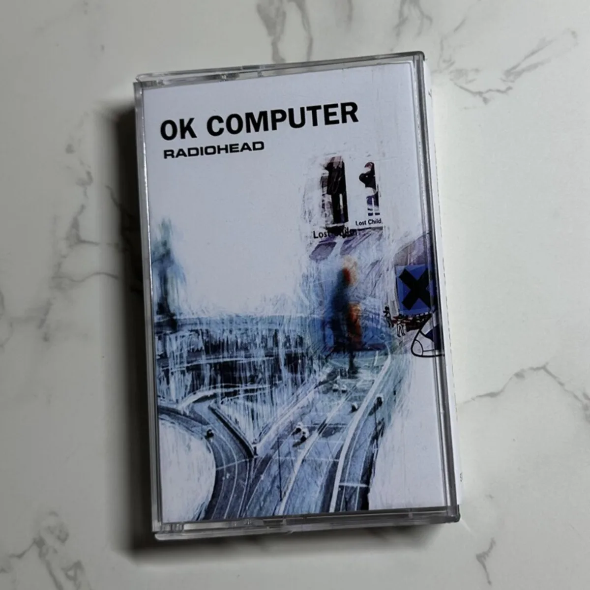 

Radiohead OK Computer Cassette Tape Legendary Alternative Rock Album for Atmospheric Listening and Music Collection