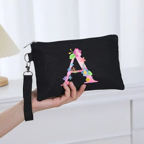 The new 26-letter printed with flower pattern, black handbag, out of the travel carry-on bag, make-up bag, storage bag