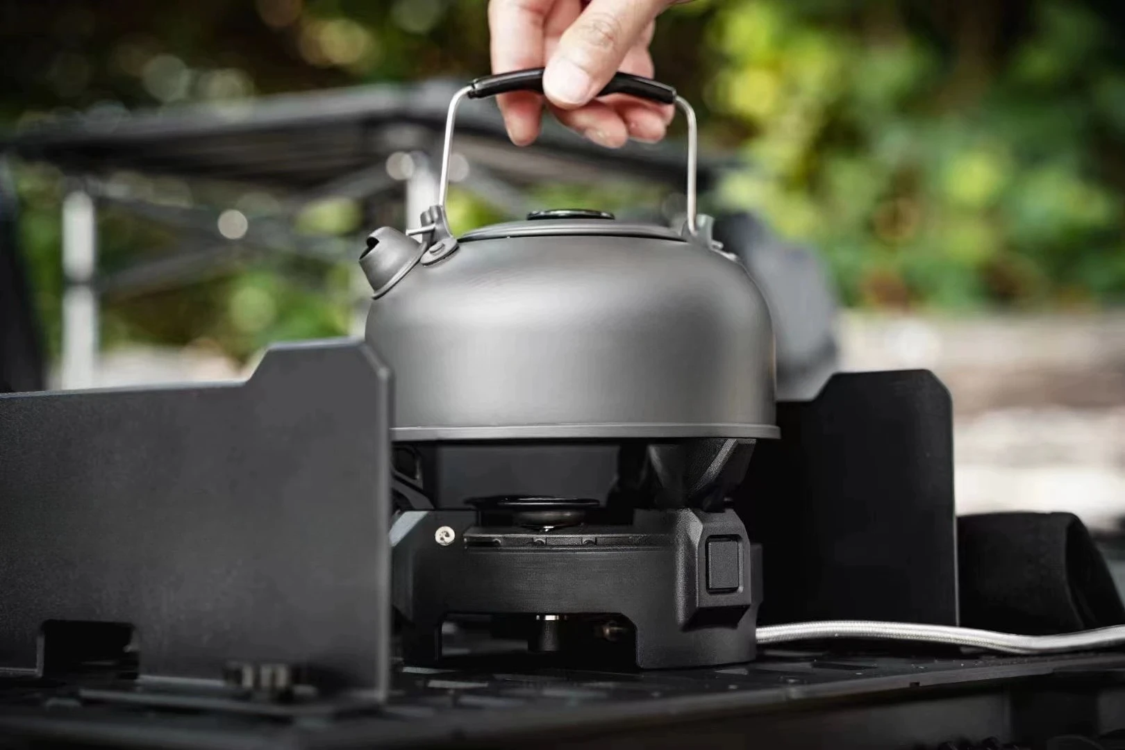 Outdoor stoves, burner head protective shells, pneumatic control connecting pipes