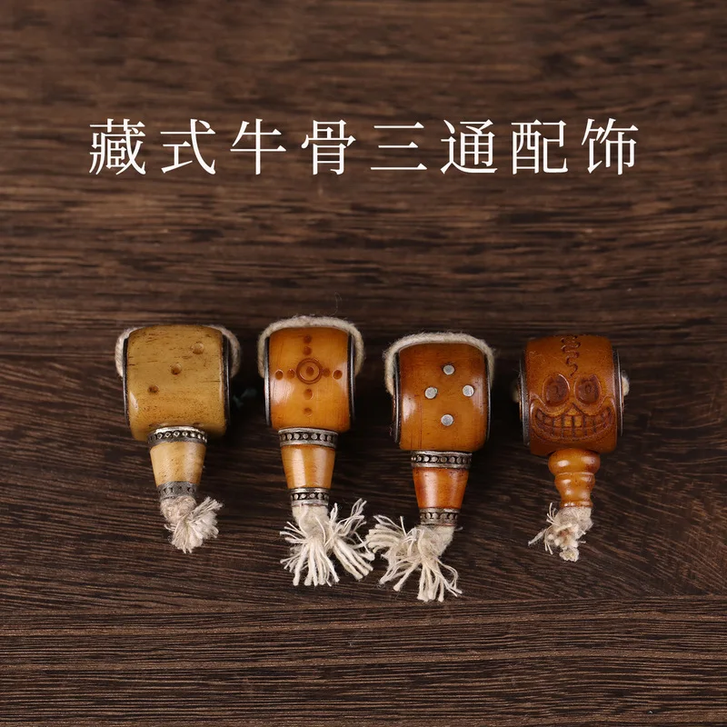 Tibetan-style decorative accessories, including a three-way connector, an old ox bone carving, a 