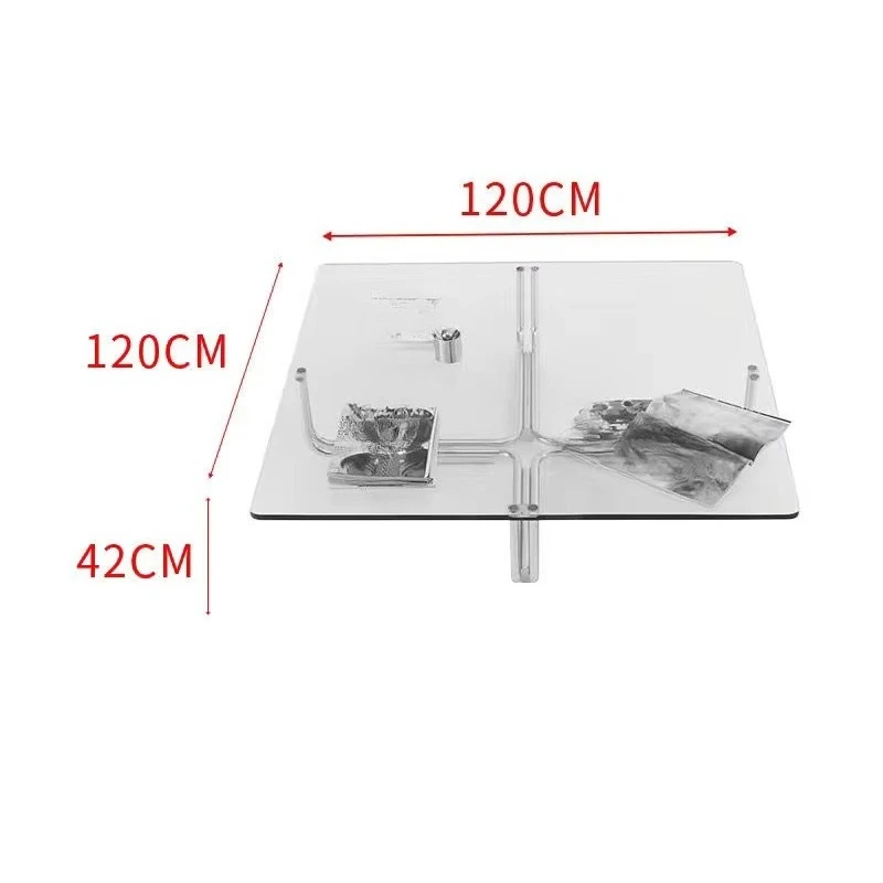 A home office with a modern square coffee table and transparent living room furniture with tempered glass and metal frames