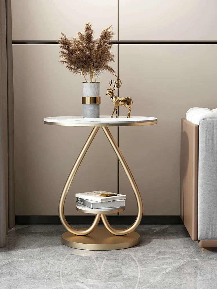 A few modern bedside tables near the luxurious sofa, simple small round table, small apartment corner in the living room, and