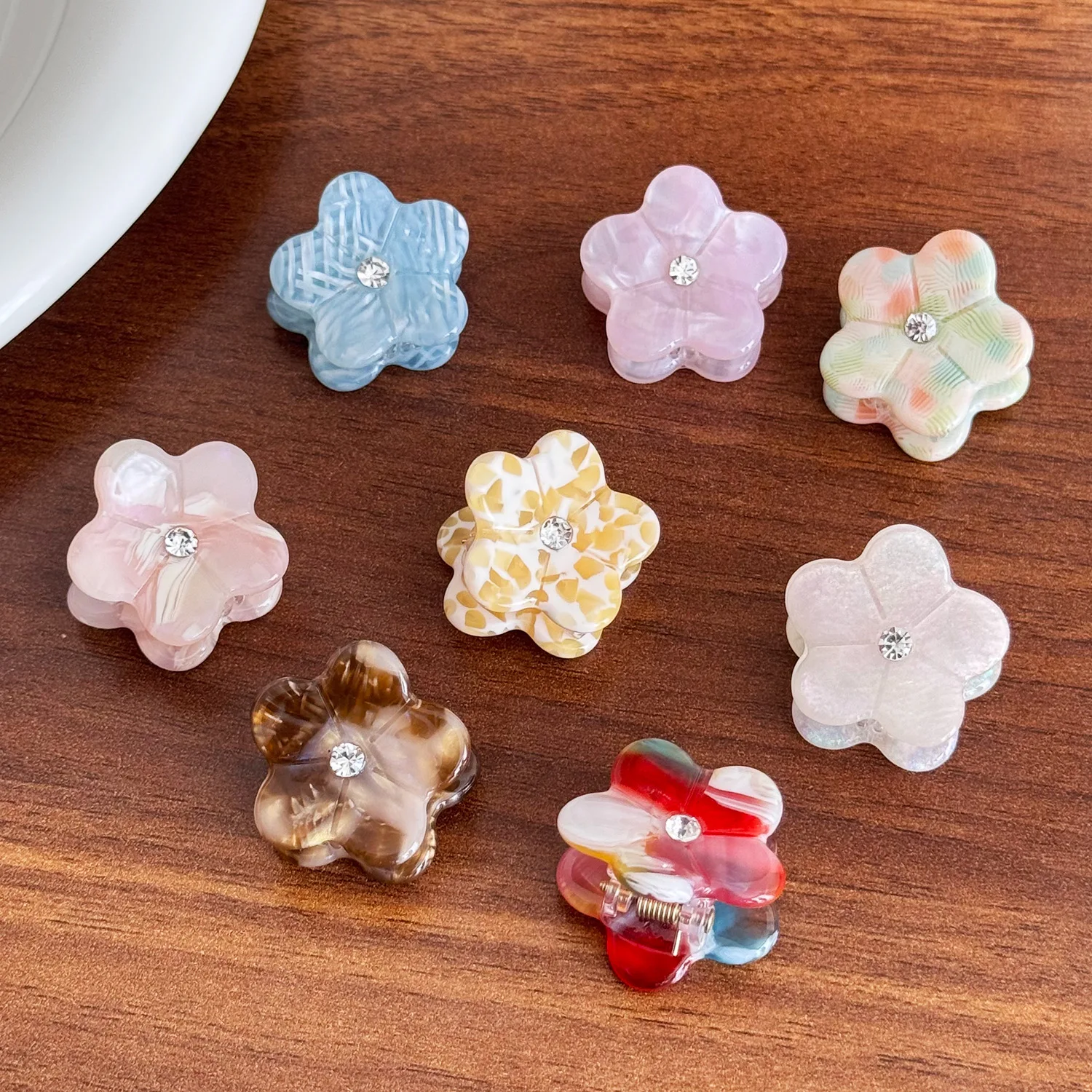 

Mini Flower Hair Clip with Small Rhinestones, Elegant Acetate Mini Clip, Side-Swept Bangs, and Loose Strands Hair Accessory