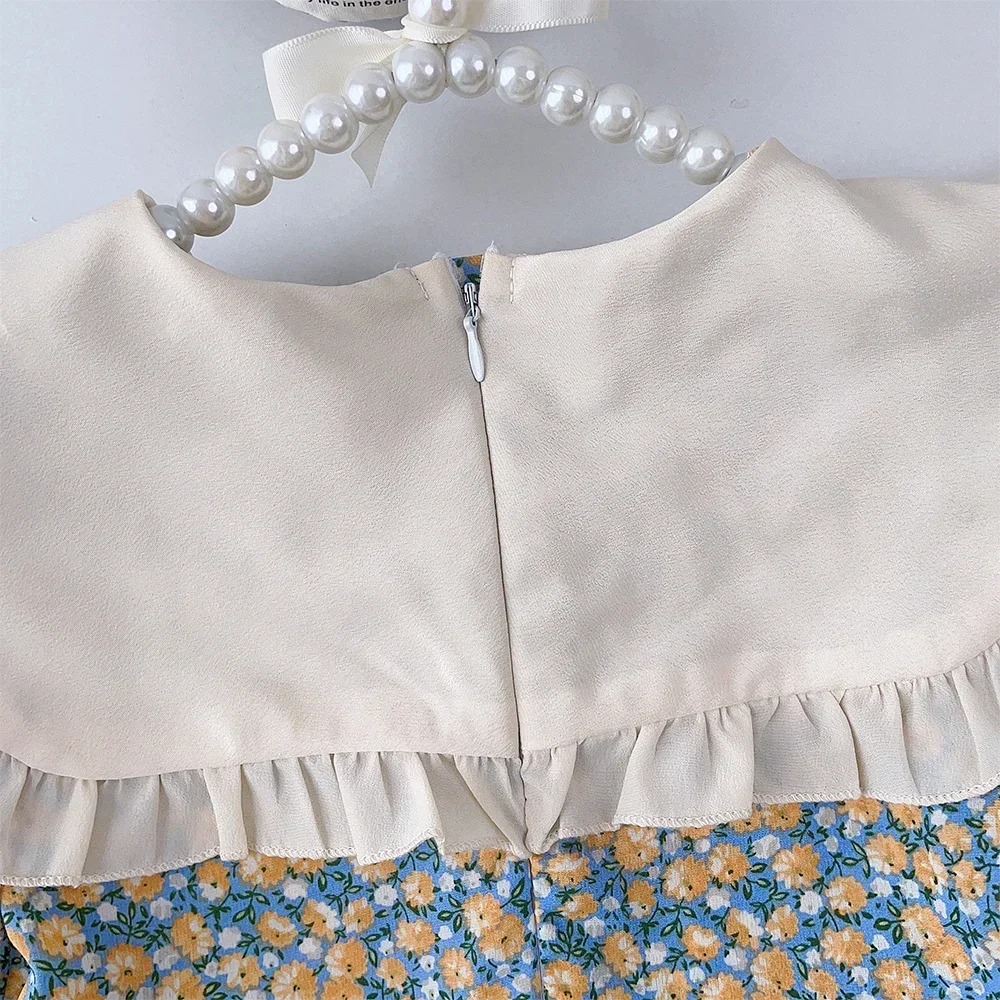 فساتين Bear Leader الصيفية العصرية للفتيات بأكمام قصيرة وطية صدر السترة وديكور فيونكة فستان مطبوع عليه زهور