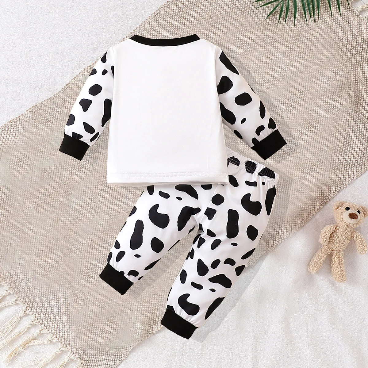 Two piece cute and fashionable black and white spotted cow print long sleeved round neck top and pants set for baby boys