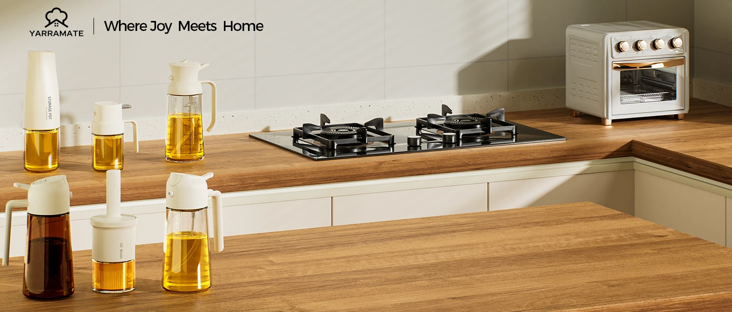 Kitchen countertop with gas stove, mini oven, and various glass containers filled with liquids. Wooden surface contrasts with white cabinets, showcasing modern kitchen design elements.