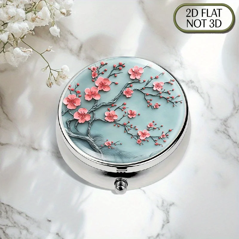 1 flat, portable, round metal pill box, featuring a pattern of cherry blossoms and branches, with a light blue background and pink flowers. This stylish storage box is perfect for storing vitamins and medication, and can also serve as a multi-functional storage solution, suitable for S