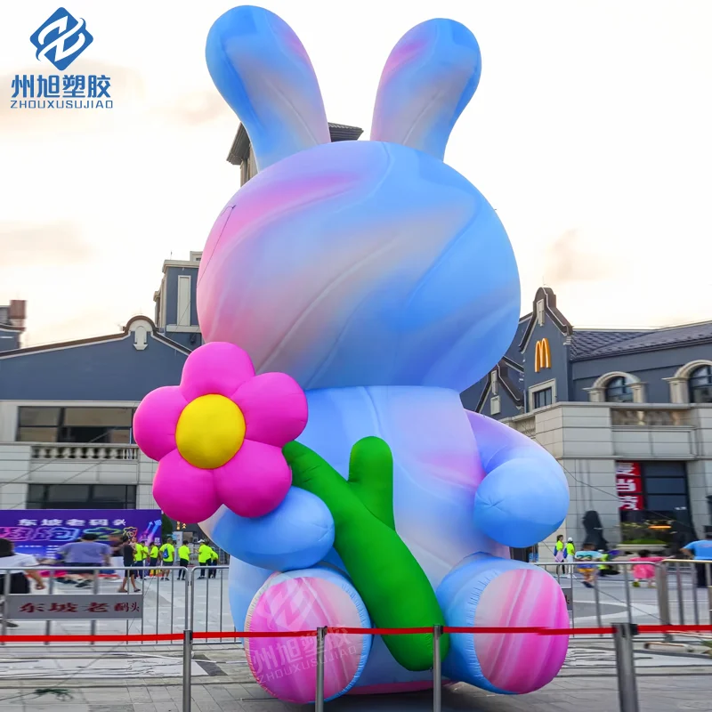 Giant inflatable colorful rabbit holding flowers, suitable for decorative props in outdoor park activities.