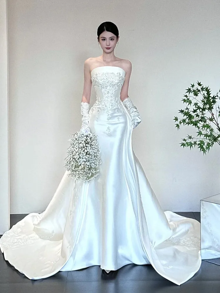 A new high-end custom-made dress with strapless satin fishtail and large drag tail
