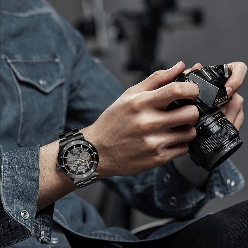 

Relojes Montre Mens Skeleton Automatic Mechanical Watch Roman Number Dial Wrist Watch Black Stainless Steel Band Watch Nice Gift