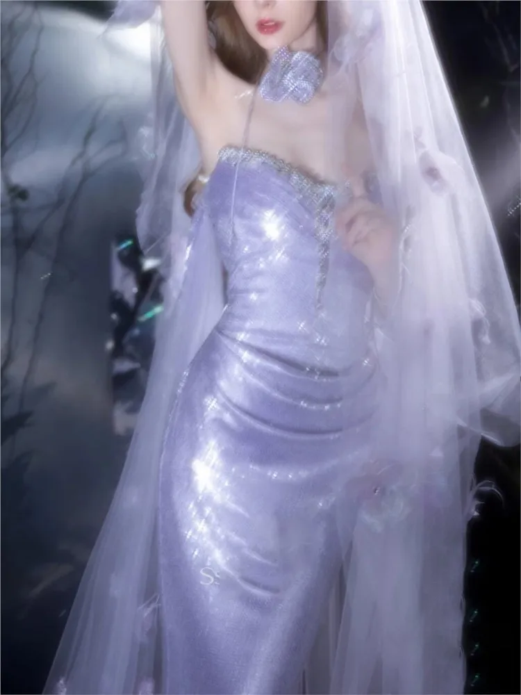 A light purple host toasts one-shoulder model walking the runway beaded into dress