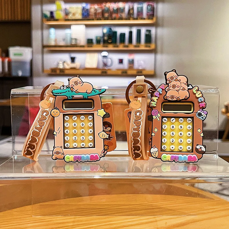 2025 nuevo llavero de calculadora Capibala lindo llavero de capibara de dibujos animados estudiante mochila colgante temporada escolar pequeño regalo