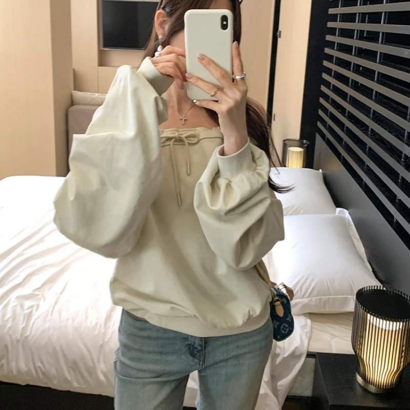 เสื้อยืดผู้หญิงคอเฉียง แขนยาว สไตล์เกาหลี ลำลอง หลวม ผูกเชือก รุ่นใหม่ ปี 2025 สำหรับฤดูใบไม้ผลิและฤดูใบไม้ร่วง