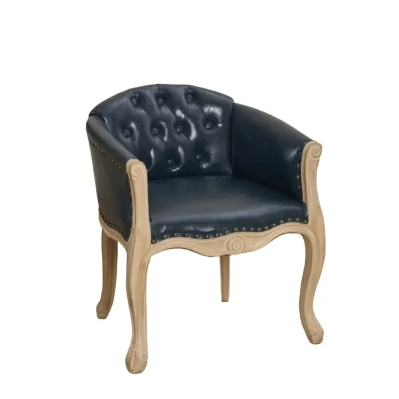 Vintage tufted accent chair with carved wooden legs upholstered in mixed fabrics