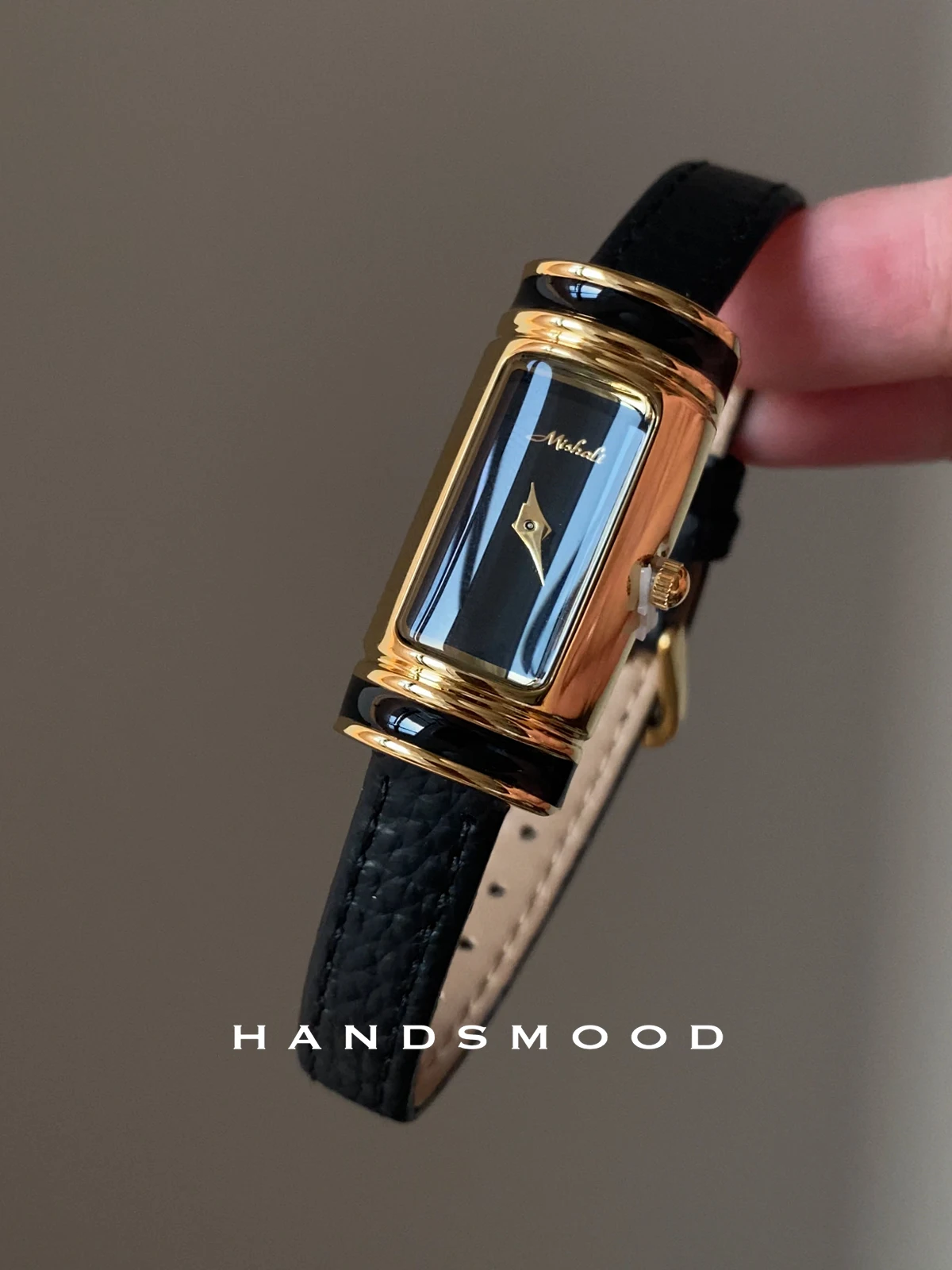 

Small gold bar black gold watch with a sophisticated and stylish feelfeaturing a versatile leather design and understated luxury