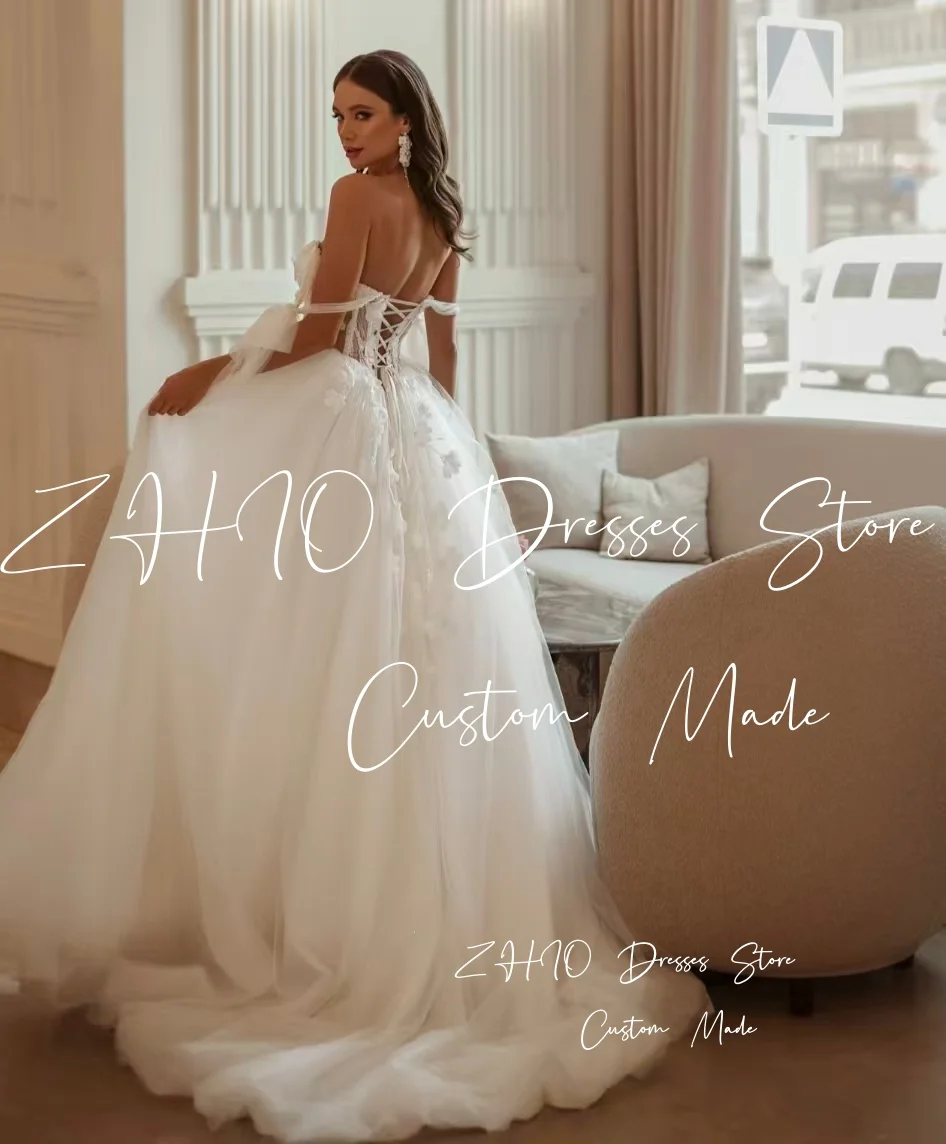 ZHIO Fiori eleganti Abito da sposa Fiocco senza spalline Corsetto Sweep Train Avorio Tulle Abito da sposa Abiti da sposa personalizzati