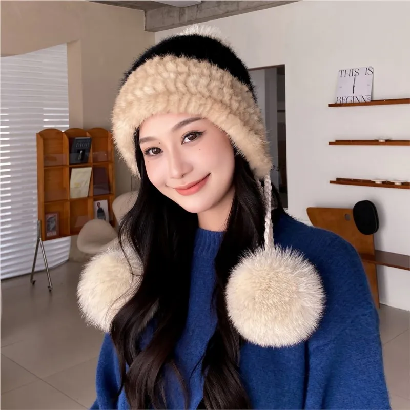 A fur hat for women is warm fashionable cute and versatile in autumn winter knitted with pom-poms