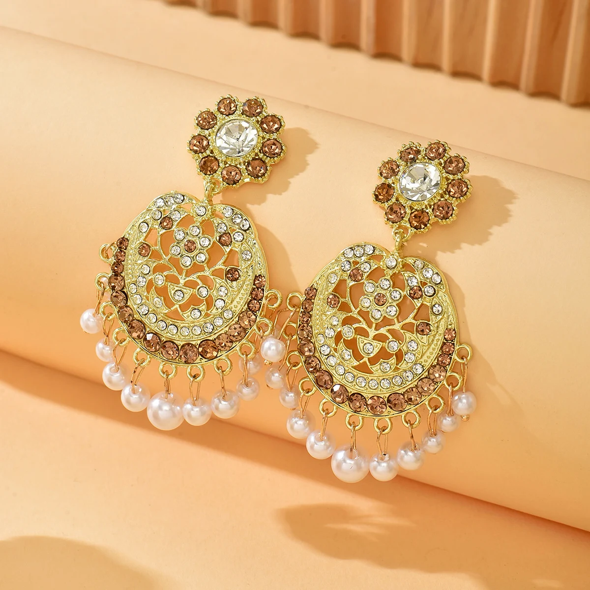 

A Pair Of Retro Court-Style Round Pearl Drop Earrings With Intricate Hollow-Carved Flowers And A Sophisticated Design.