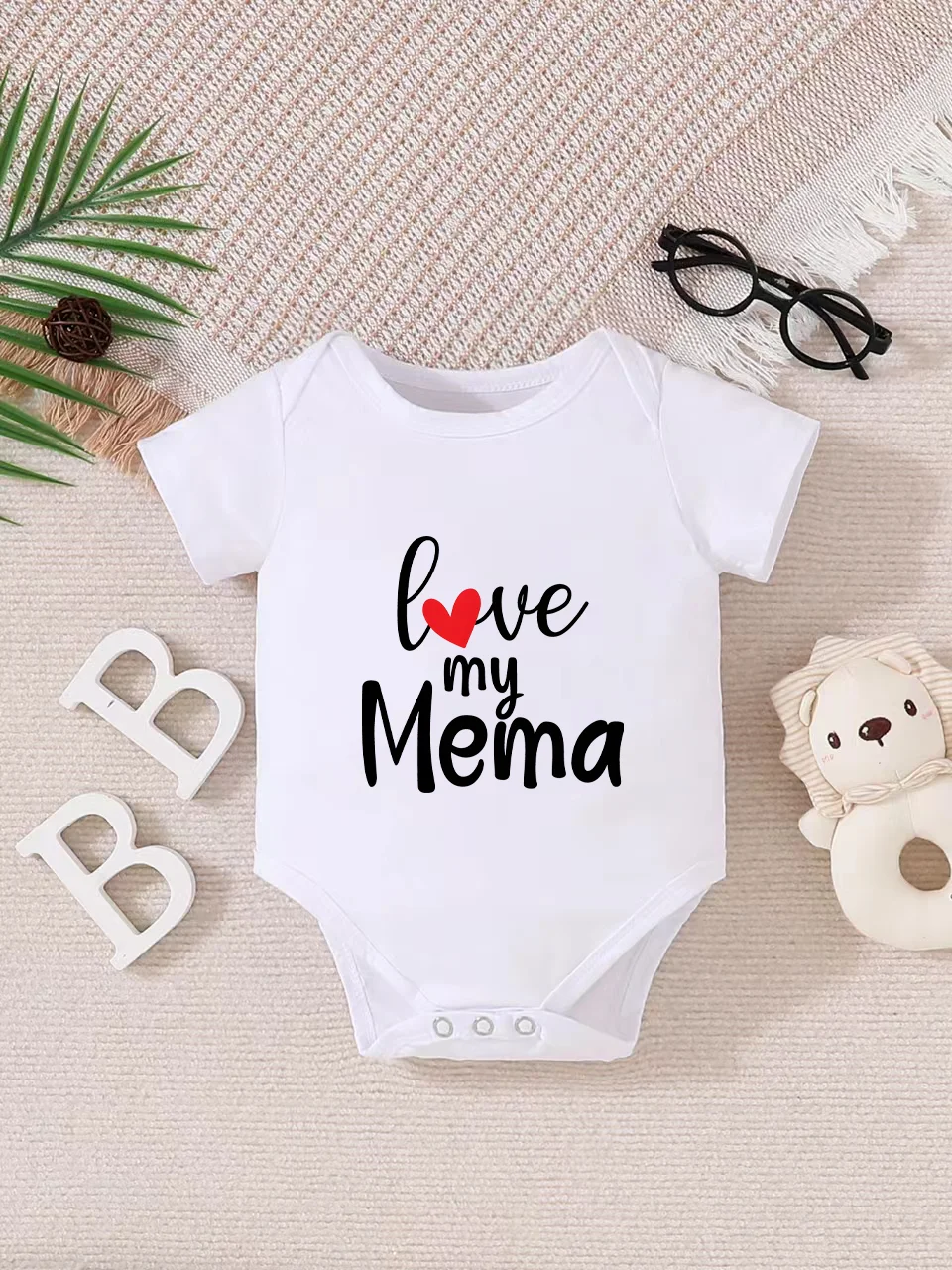 Playful letter-printed baby short-sleeve triangle bodysuit. Button closure for easy dressing, machine washable
