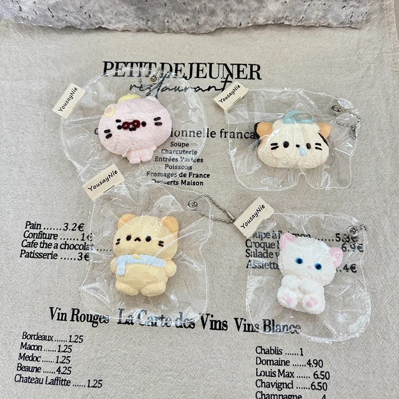 Slow-rise animal squeeze toys in various styles: a kitten with a cold, a blue-eyed kitten, a kitten wearing a scarf, and a kitte