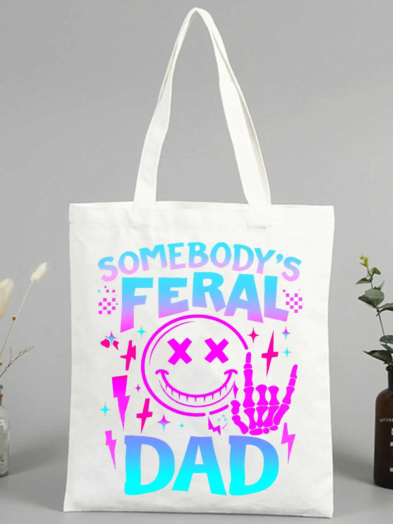 Men's slogan-style canvas tote bag with smiley graphic and skeleton hand design, perfect for casual daily use and streetwear