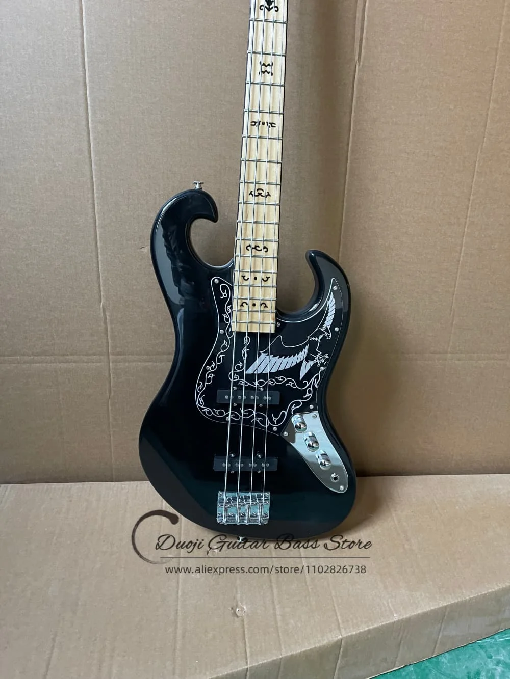 Classic 4 string black bass guitar, solid wood body, eagle wing pattern, fixed bridge, hollowed-out headstock, black pickupguard