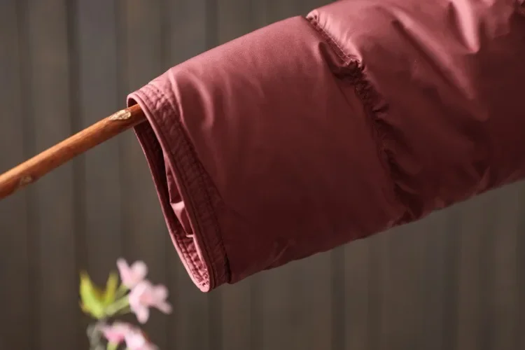 Damska kurtka puchowa w stylu retro etno na zimę 2025, z literackim i artystycznym zapięciem zapewniającym ciepło.