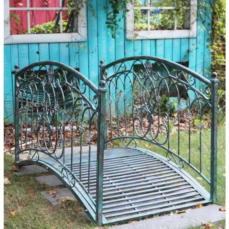 Old bold outdoor wrought iron arch bridge