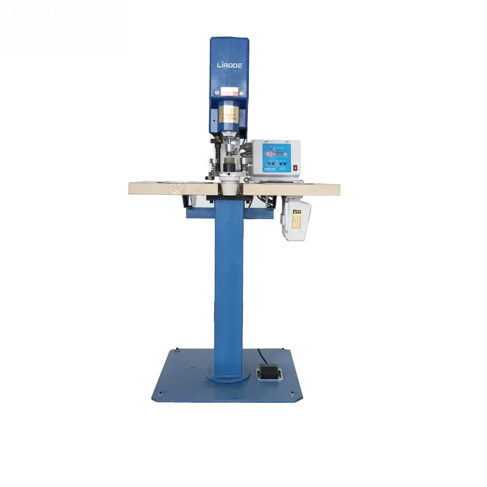 

Fabric covering button making machine