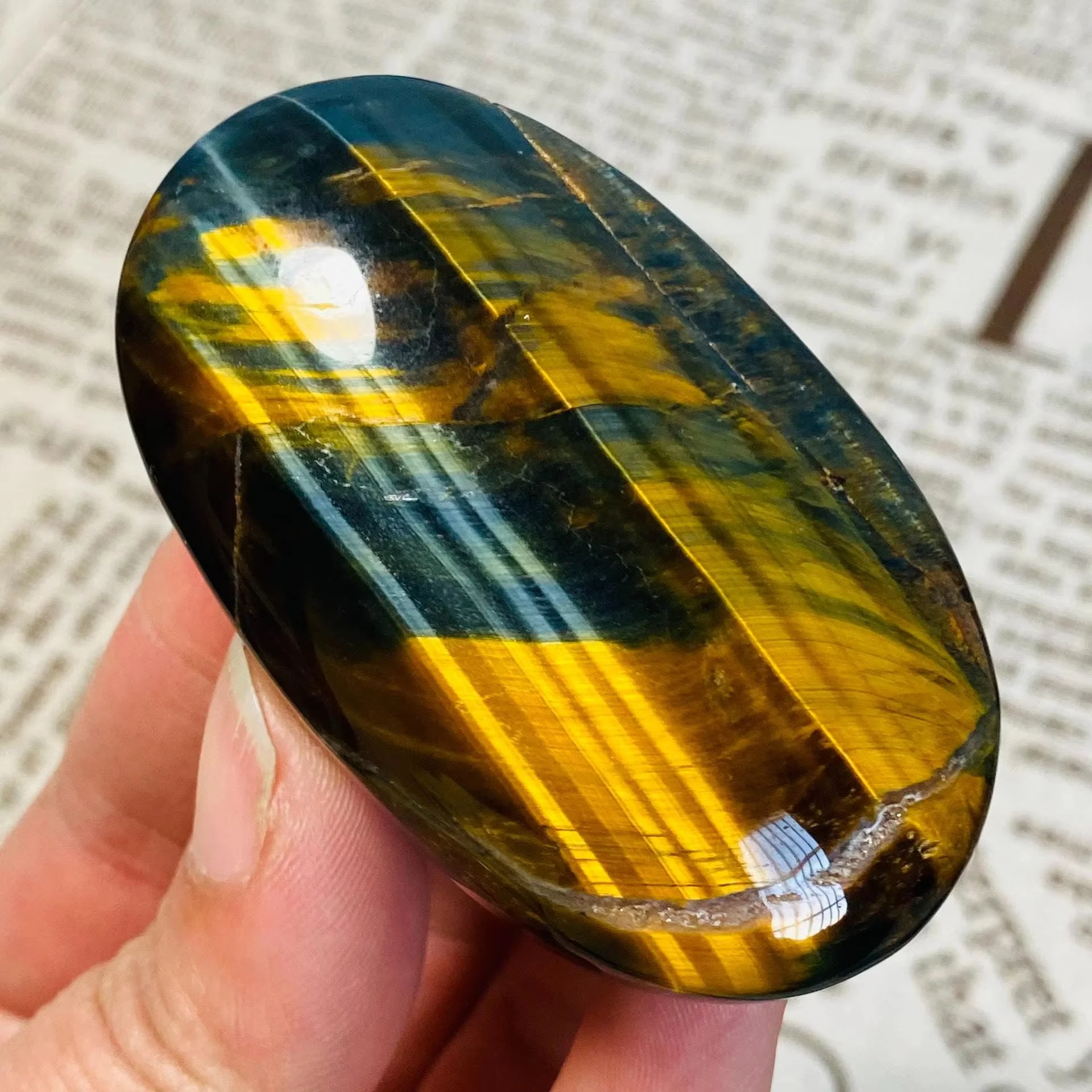 One natural blue tiger's eye palm stone - mirror polished with gold stripes, suitable for Christmas, graduation ceremonies.