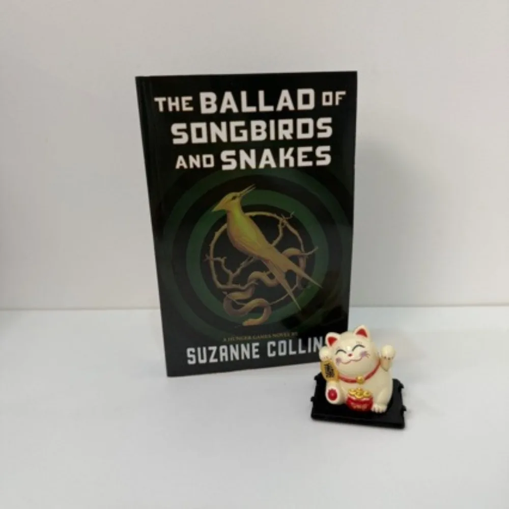 

The Ballad of Songbirds and Snakes by Suzanne Collins Hunger Games Prequel President Snow‘s Origin Story Dark Dystopian Tale