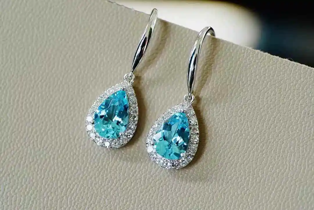 

1.6 carat teardrop-cut aquamarine, radiant with brilliant fire. Set in 18-carat gold, adorned with diamonds.