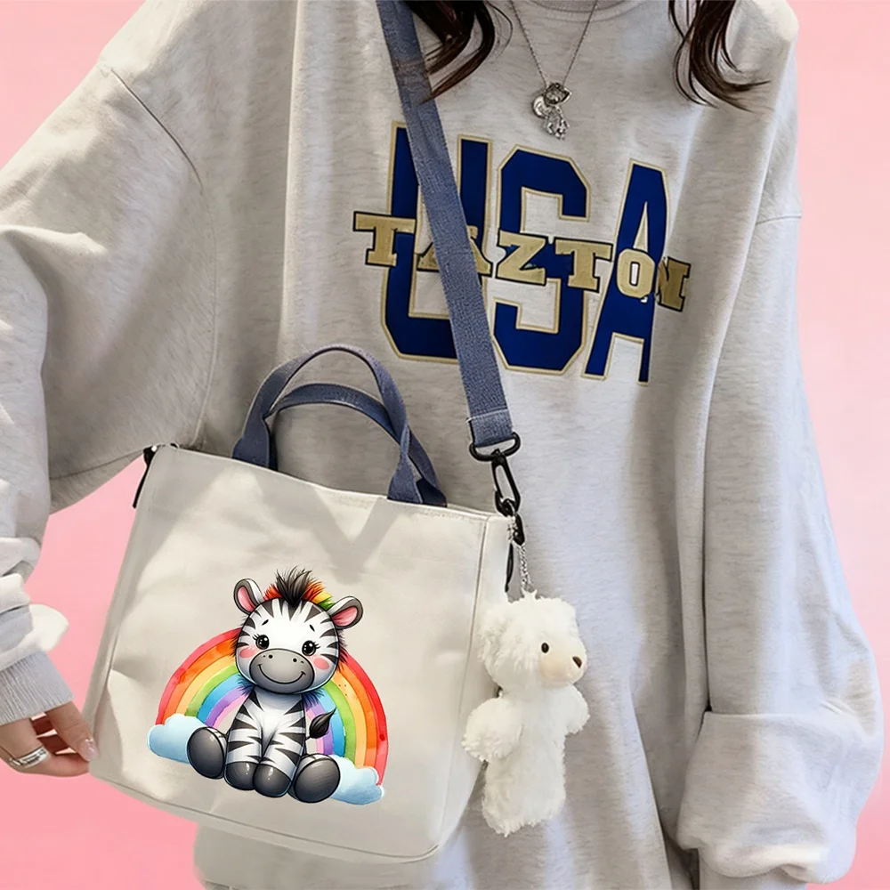 Handbags and crossbody bags featuring a rainbow baby zebra pattern—perfect for travel storage and use as a makeup bag.