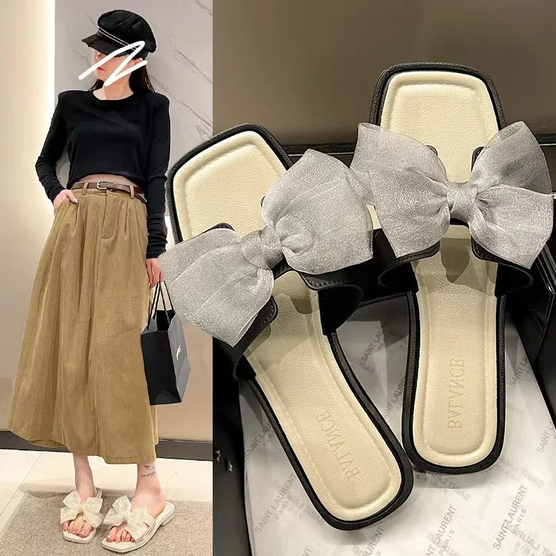 

Женские повседневные тапочки с бантом, милые сандалии на мягкой подошве из органзы на плоском каблуке из ПВХ, пляжная одежда, летние нескользящие тапочки