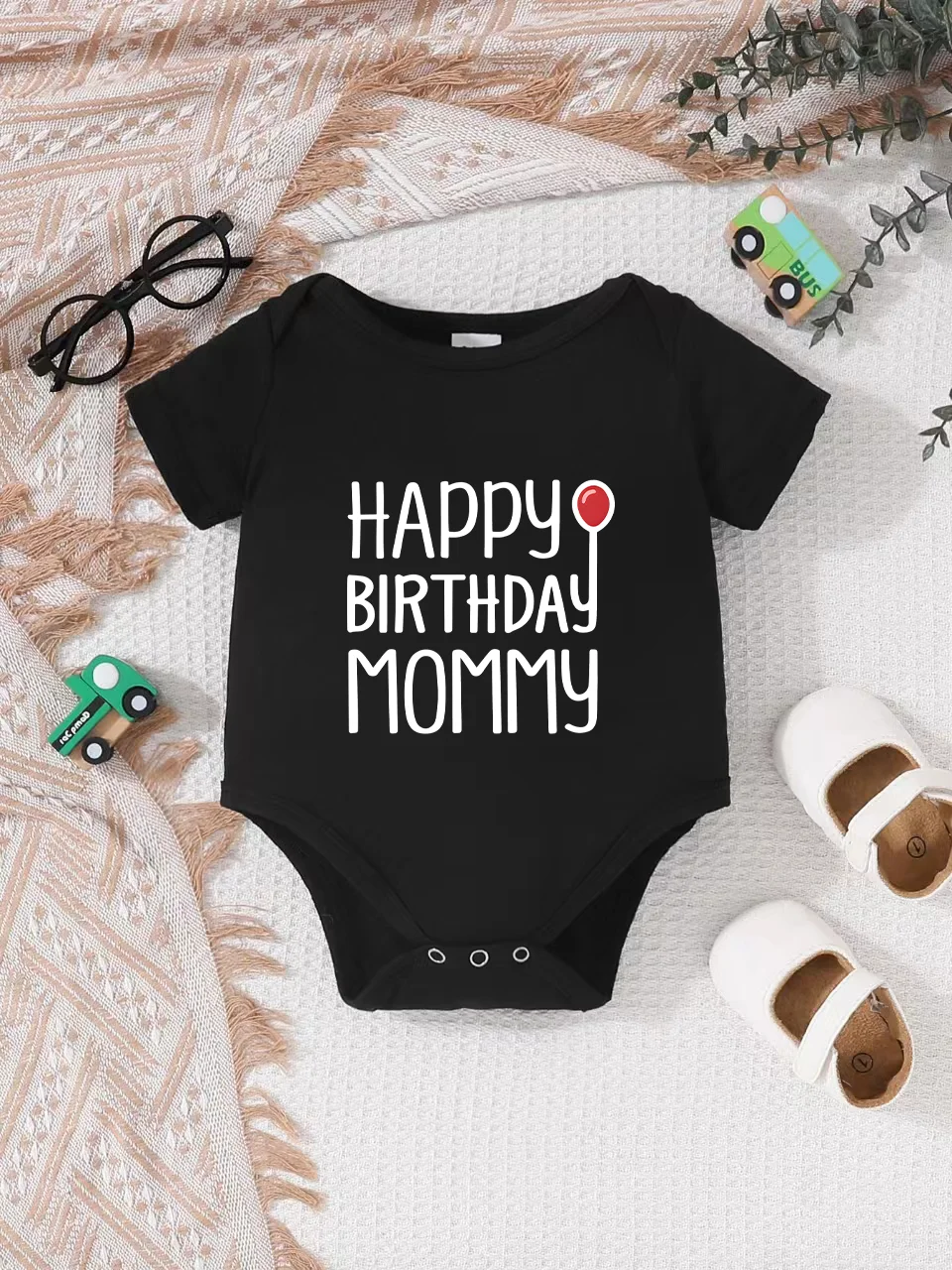 Playful letter-printed baby short-sleeve triangle bodysuit. Button closure for easy dressing, machine washable