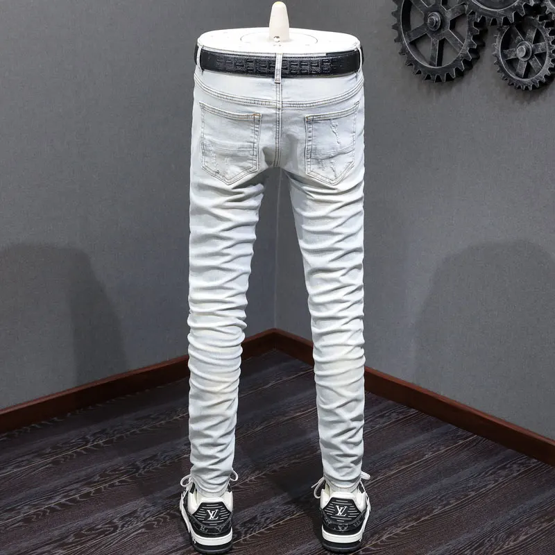 Fashionable new men's jeans with perforated patches washed, nostalgic stretch, slim fit, retro light blue jeans, high street hip
