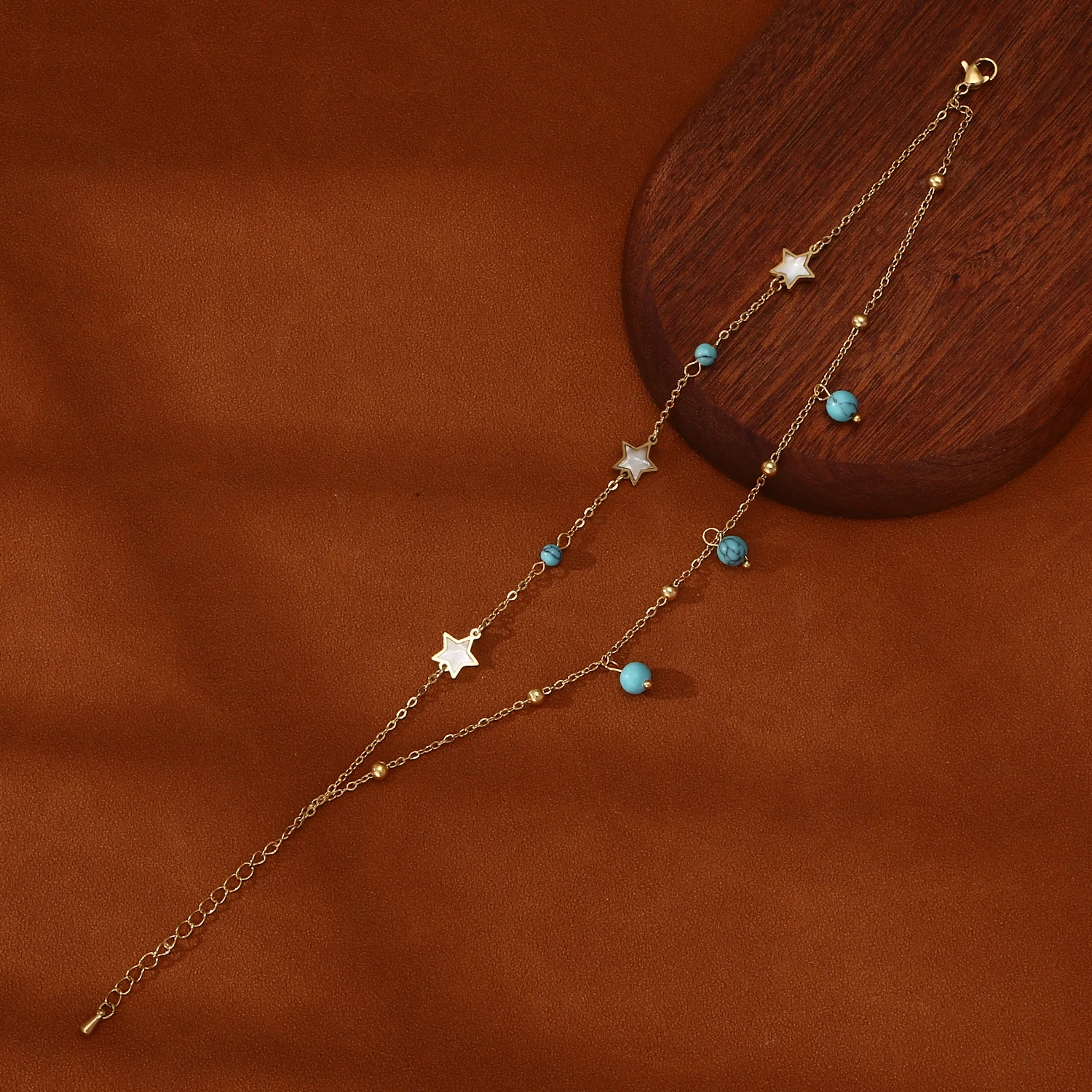 

Stylish, dainty anklet for women featuring a small blue zircon charm and a trendy, affordable-luxury design; a chic, layered acc
