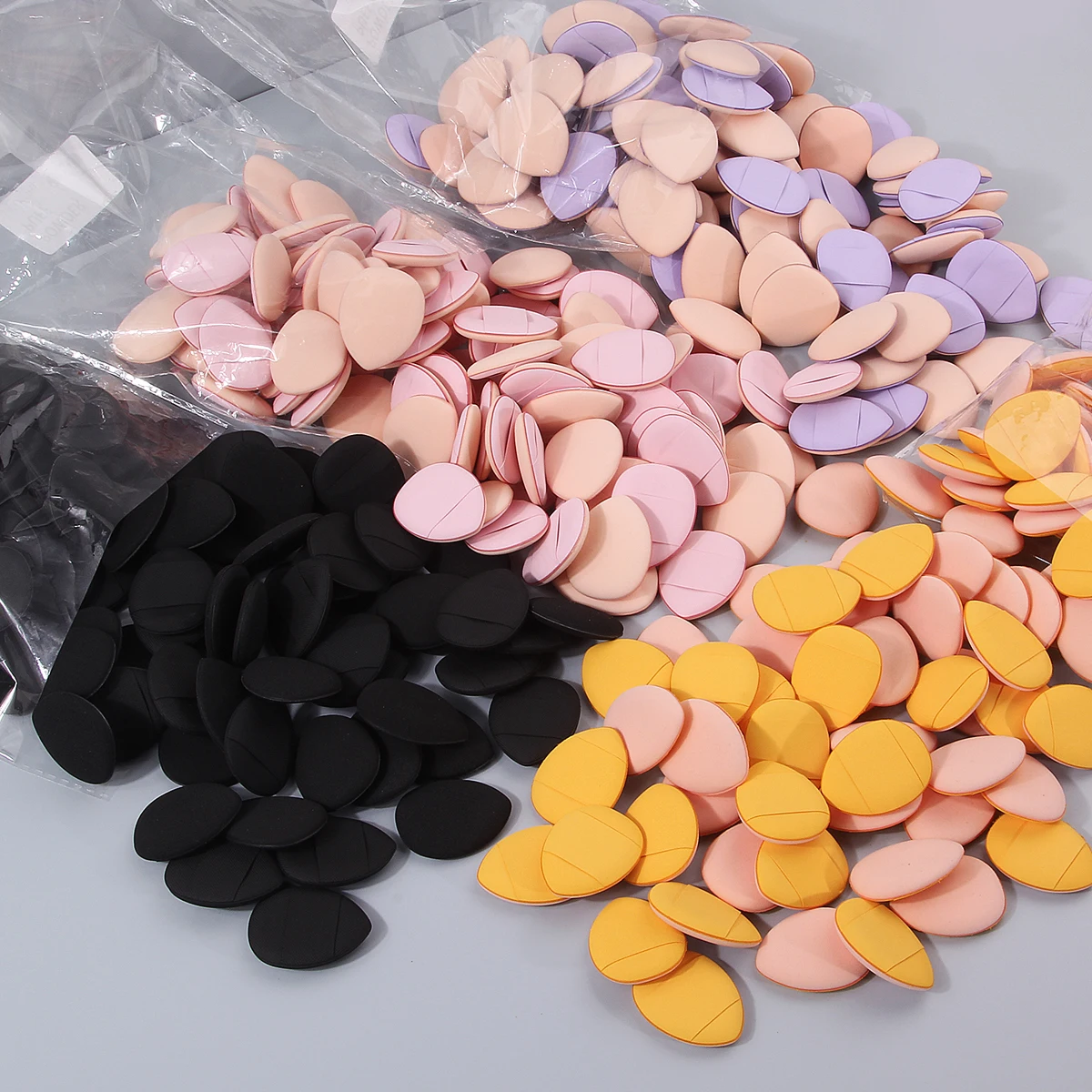 100PCS Super affordable and portable makeup thumb set, teardrop-shaped dry and wet dual-purpose non-stick mini powder puff