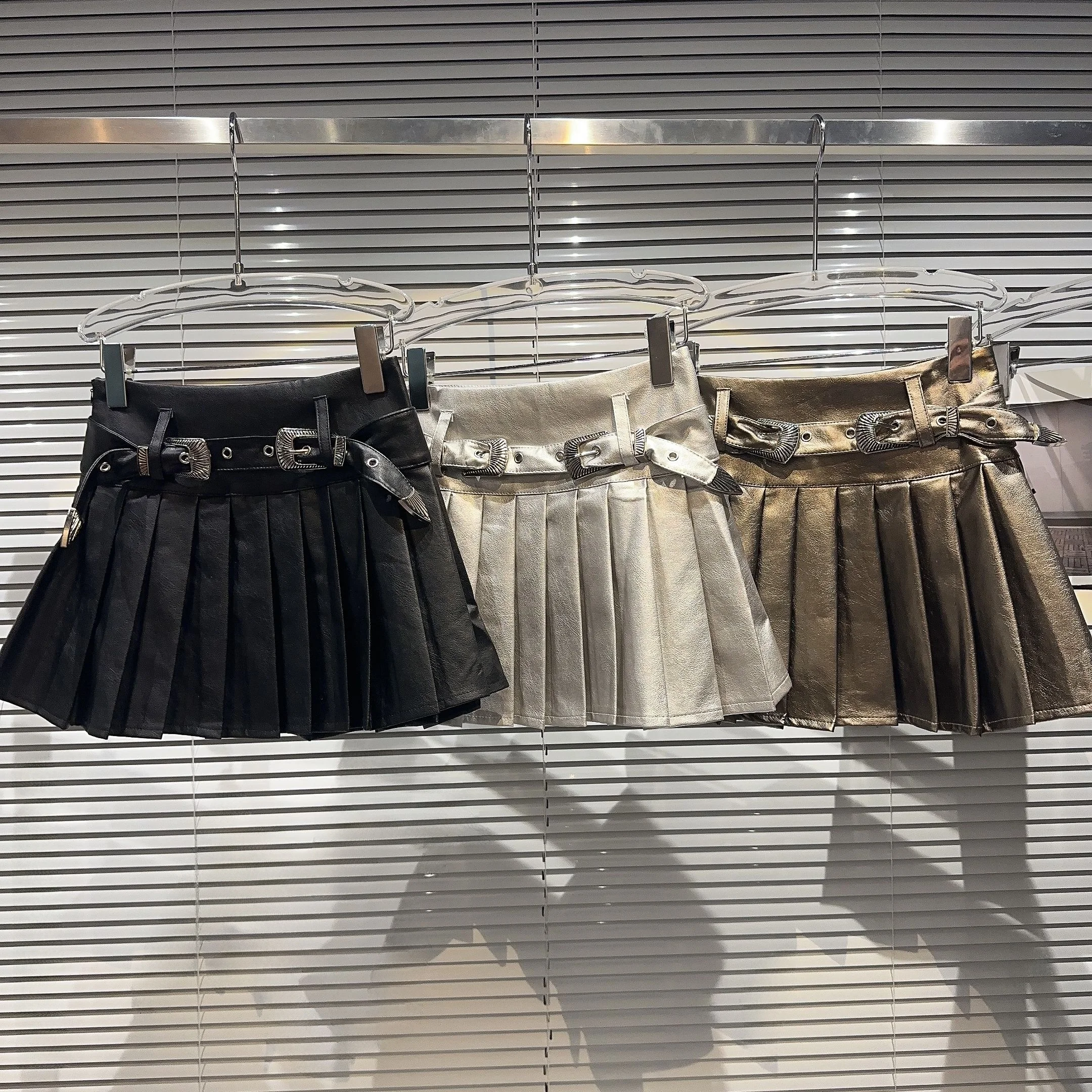 Gonna a trapezio a pieghe lucida in pelle PU intagliata retrò per ragazze alla moda Autunno Nuovo arrivo gonna ortod colore puro a vita media