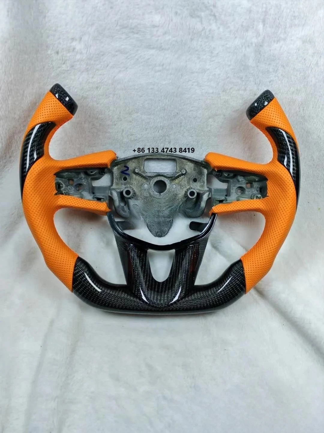 

Steering Wheel - Carbon Fiber Construction, Orange Perforated Leather, Comfort Upgrade for Daily City Commuting