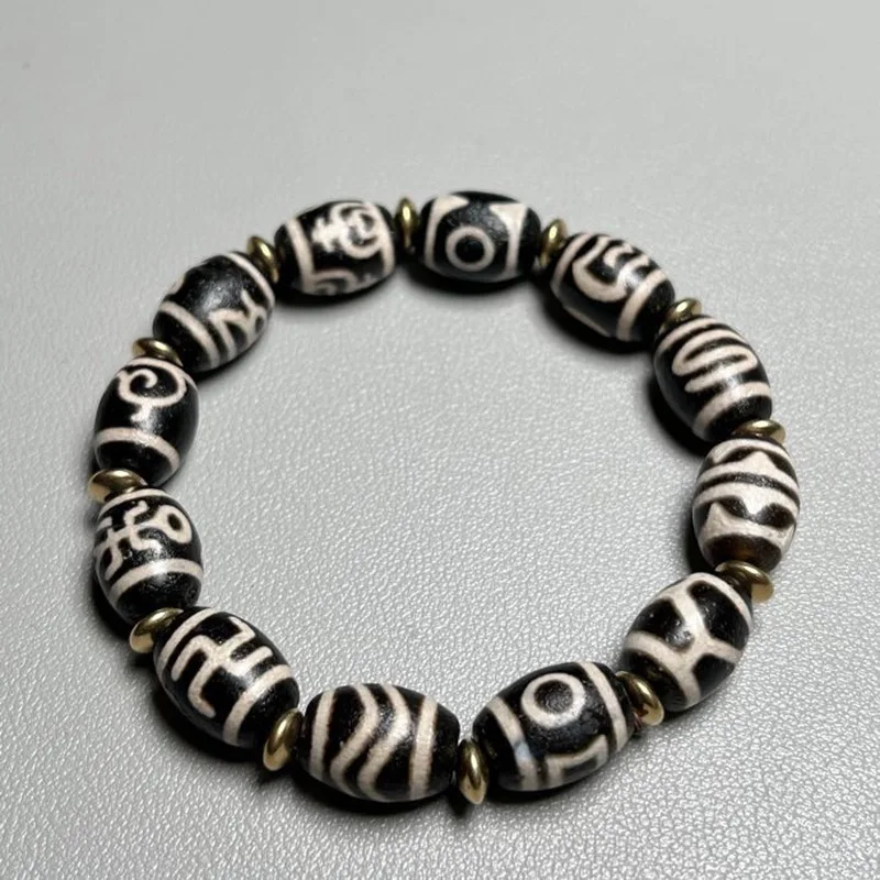 Tibetan multi-treasure bracelet with auspicious symbols: tiger tooth, three-eyed wealth god, turtle shell, single-eye money hook