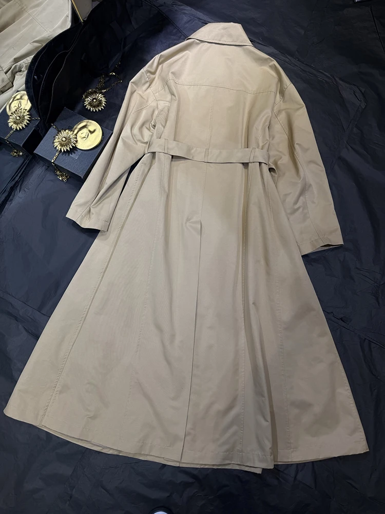 A generously belted turtleneck trench coat, a new autumn/winter 2026 style, featuring a loose, long silhouette for women.