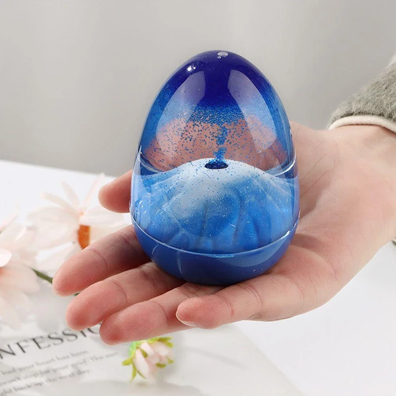 Ornement volcanique en forme d'éruption volcanique avec coquille d'œuf et sable flottant, minuteur en verre acrylique liquide en forme de sablier.