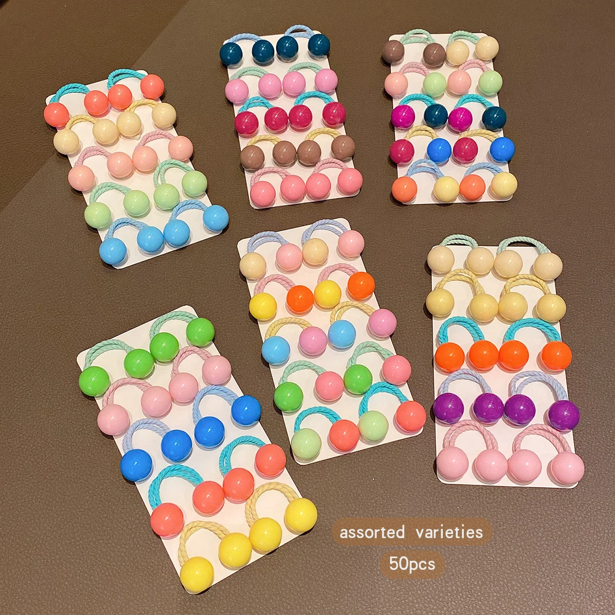 50 button style double ended rubber bands with colorful random hair loops suitable for daily use as hair accessories
