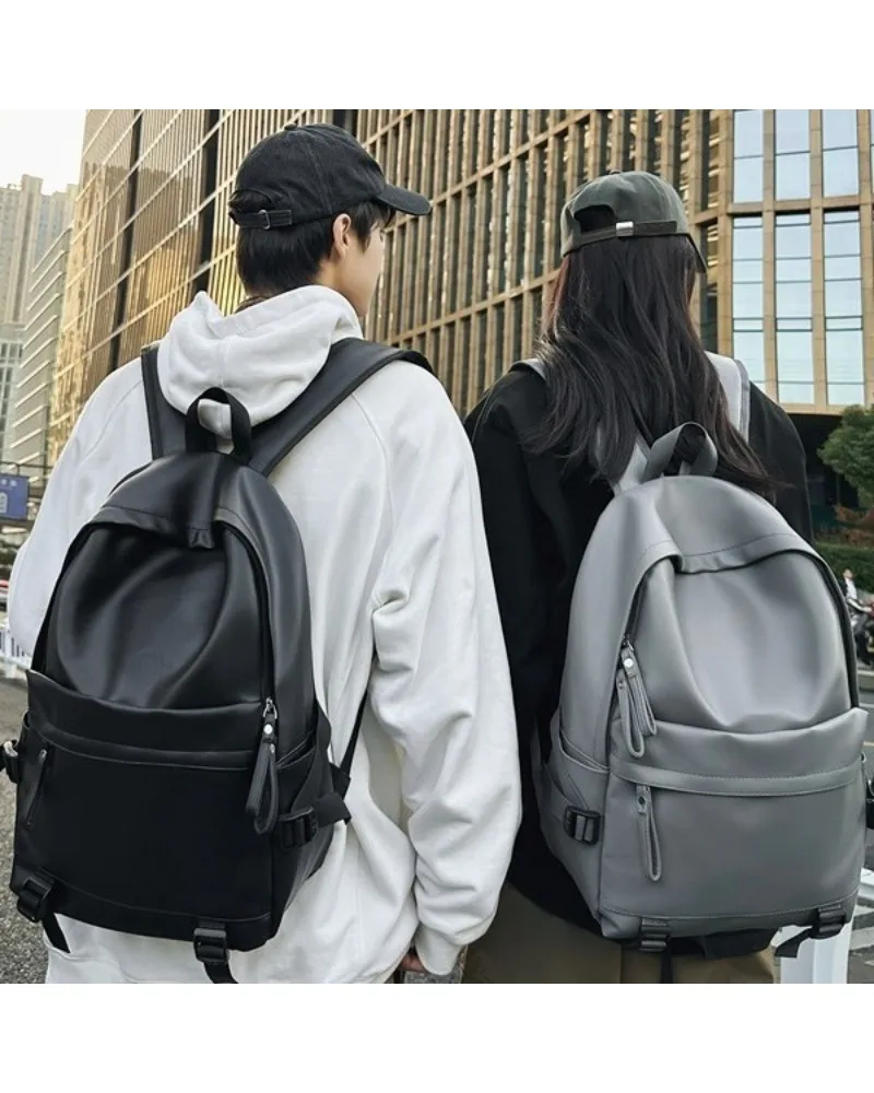 

Black minimalist casual backpack smooth synthetic leather finish simple front pocket design suitable for daily school work